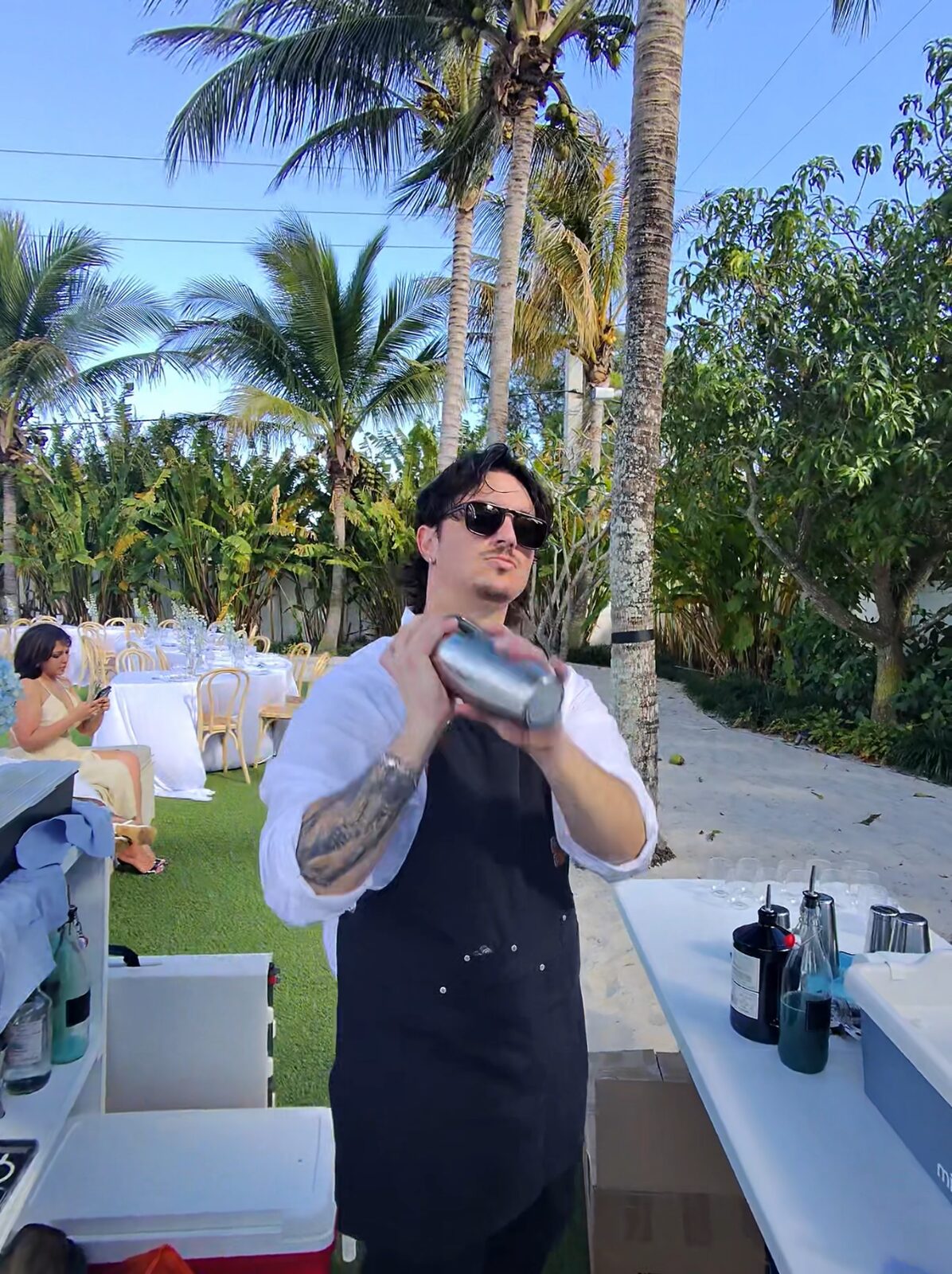 Bartender shaking a cocktail at an outdoor Palm Beach wedding