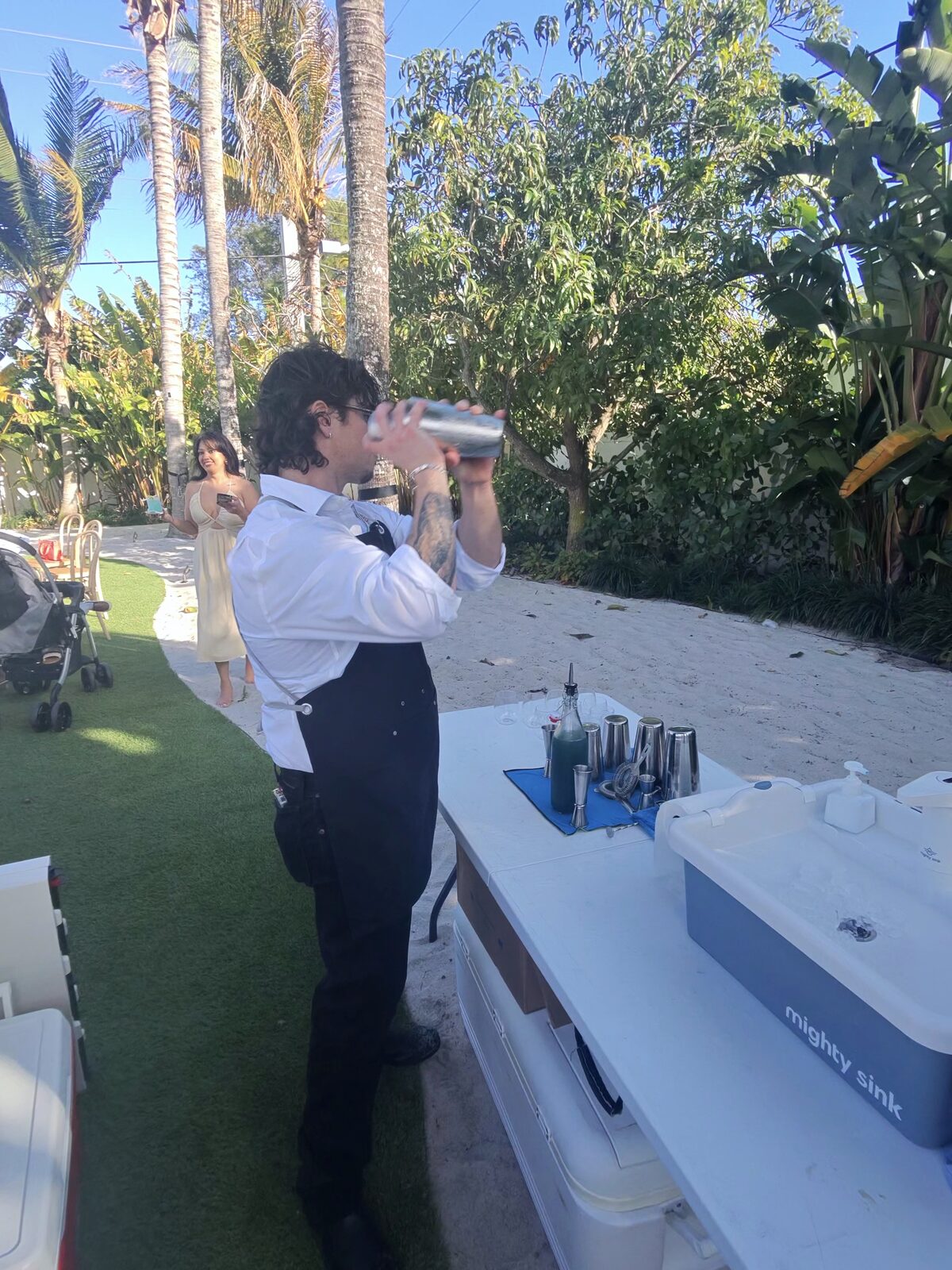 Bartender shaking a craft cocktail at the event bar station
