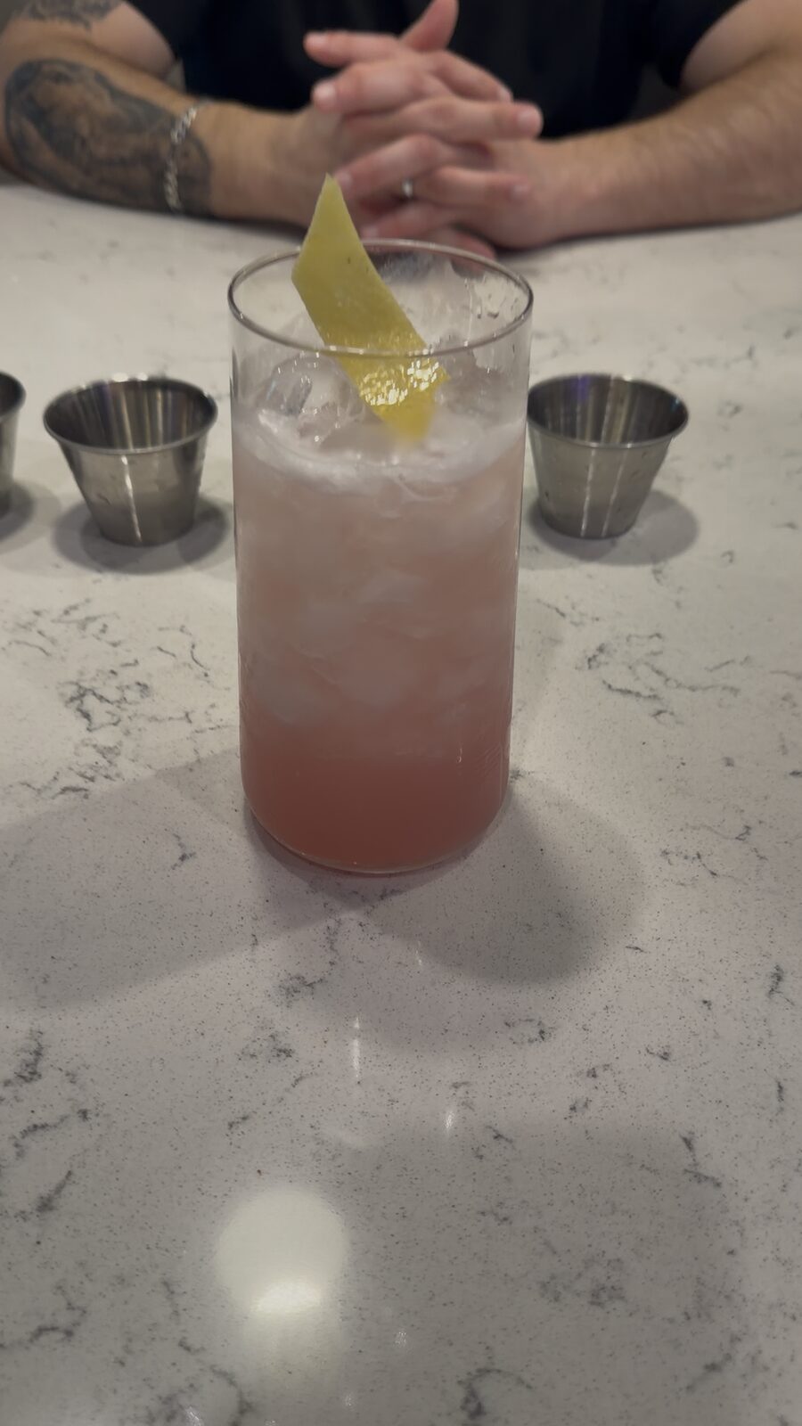 Pink marbled signature cocktail garnished for a South Florida event