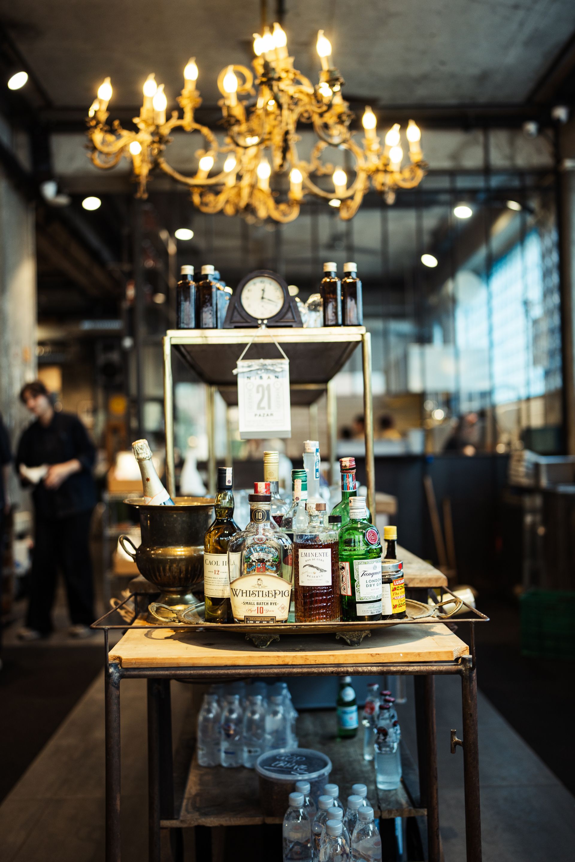 Mobile bar cart stocked with bottles and glassware at a Palm Beach event