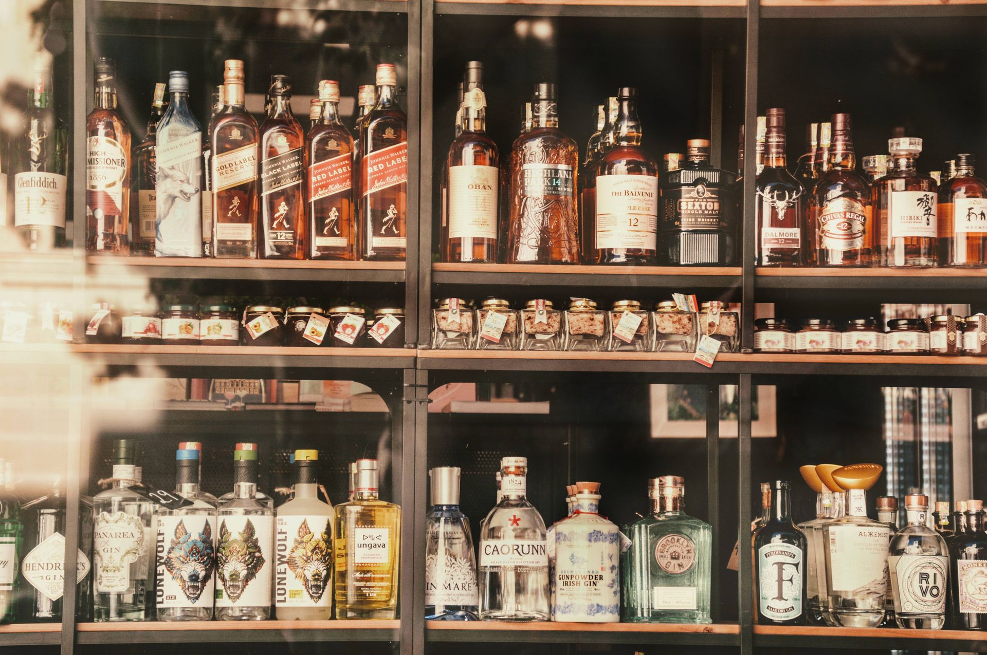 Fully stocked back bar with shelves of liquor bottles ready for a party
