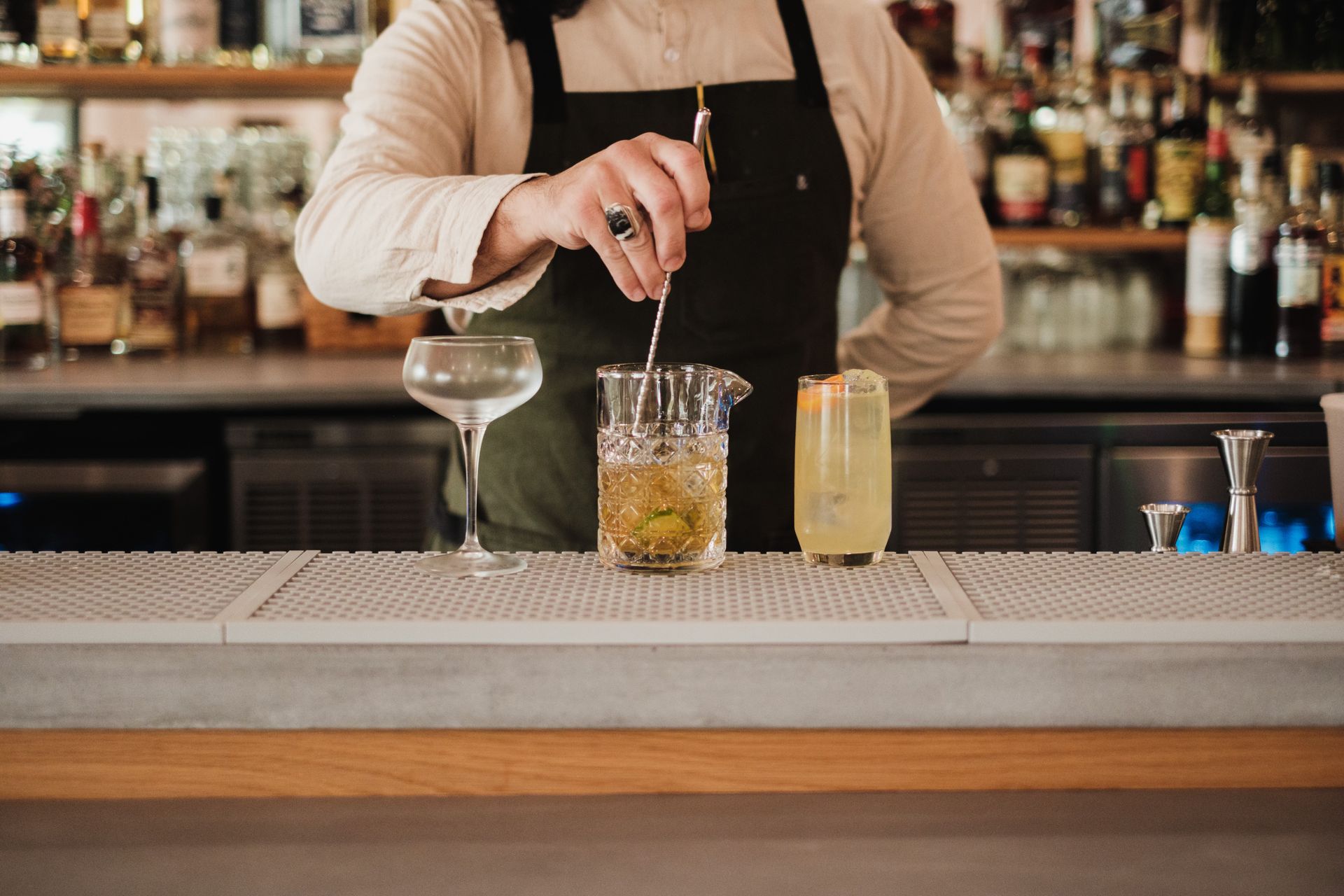 Bartender mixing a cocktail behind the bar at a Palm Beach wedding