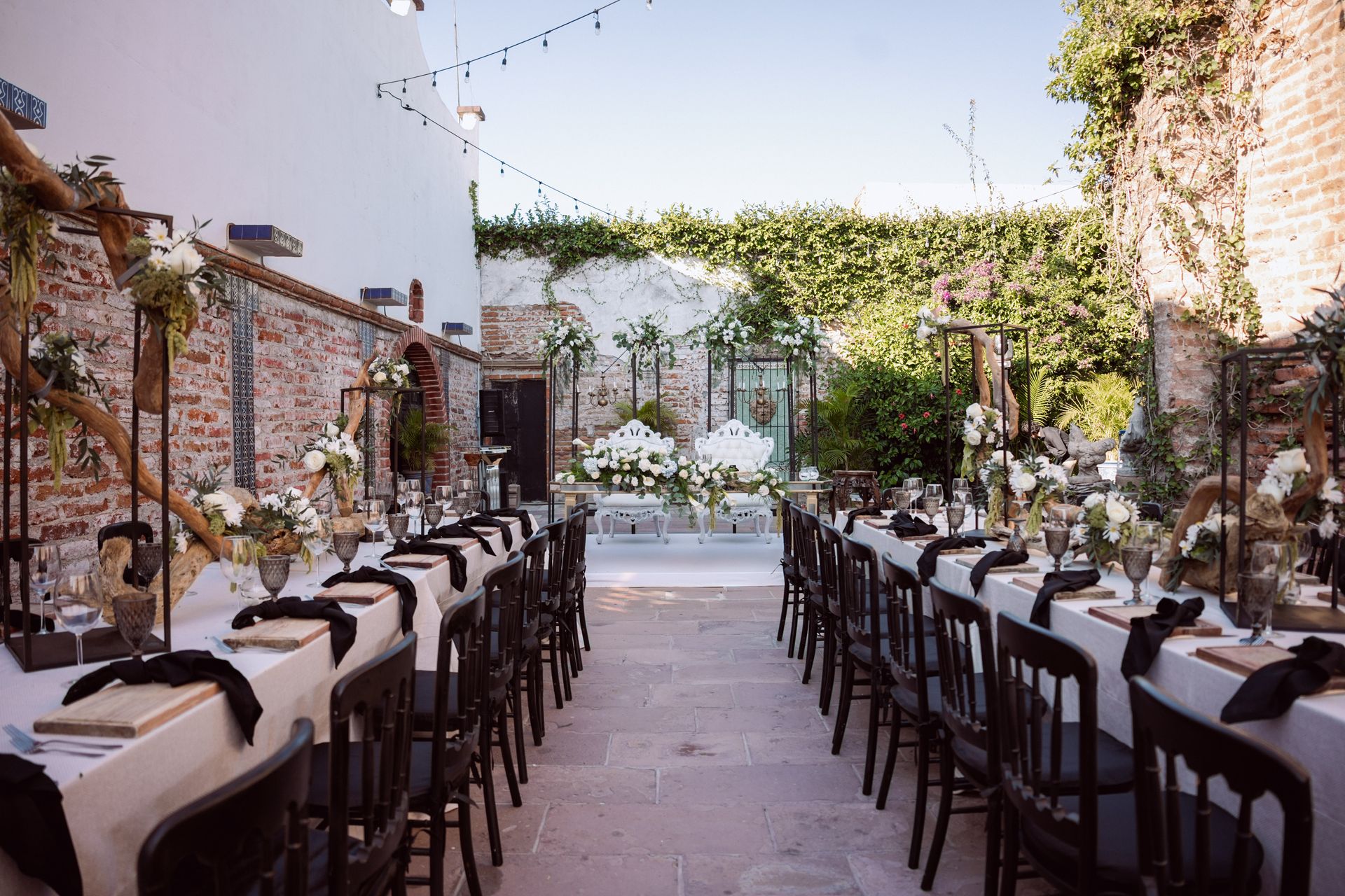 Elegant outdoor wedding reception with long tables, string lights, and florals in Palm Beach County