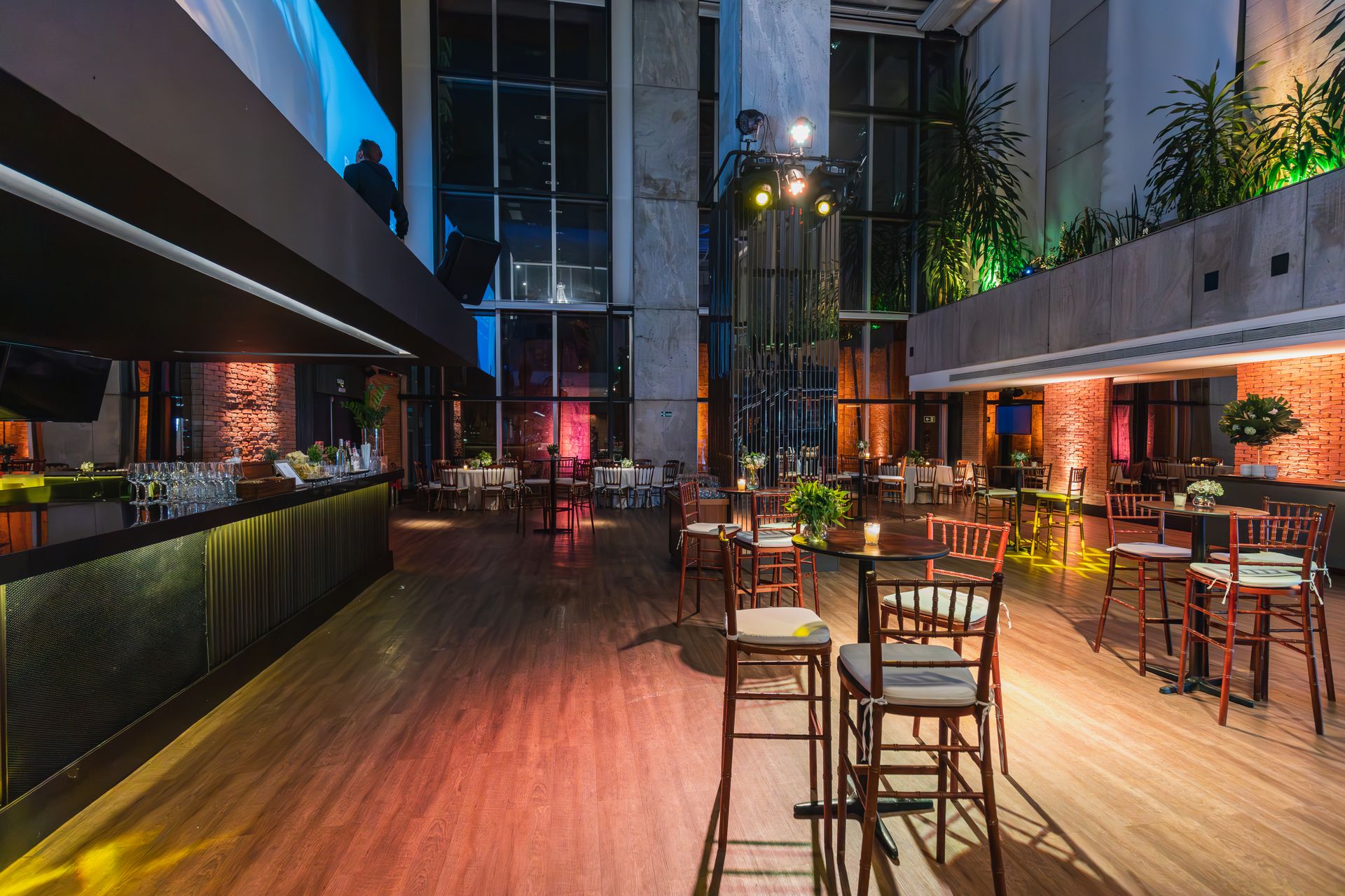 Modern indoor event venue with a full bar and dining tables set for a corporate event in Palm Beach County